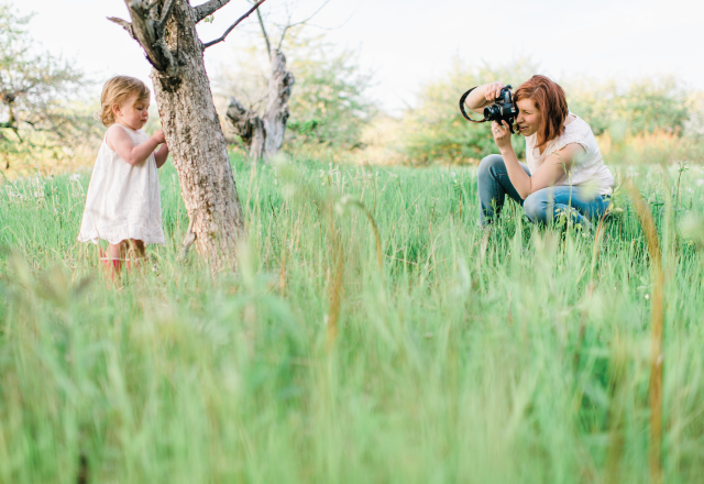 a photographer taking a photo of a baby