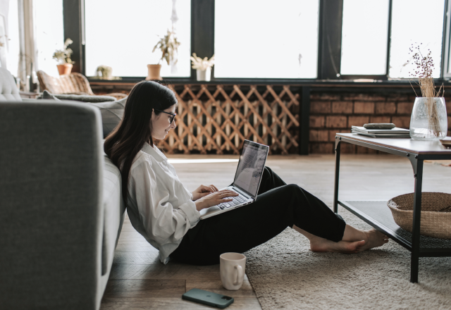 a girl on a laptop in a living room setting