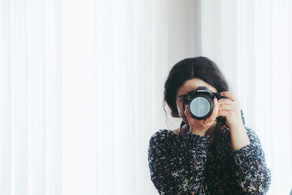 a photographer holding a camera capturing someones photo