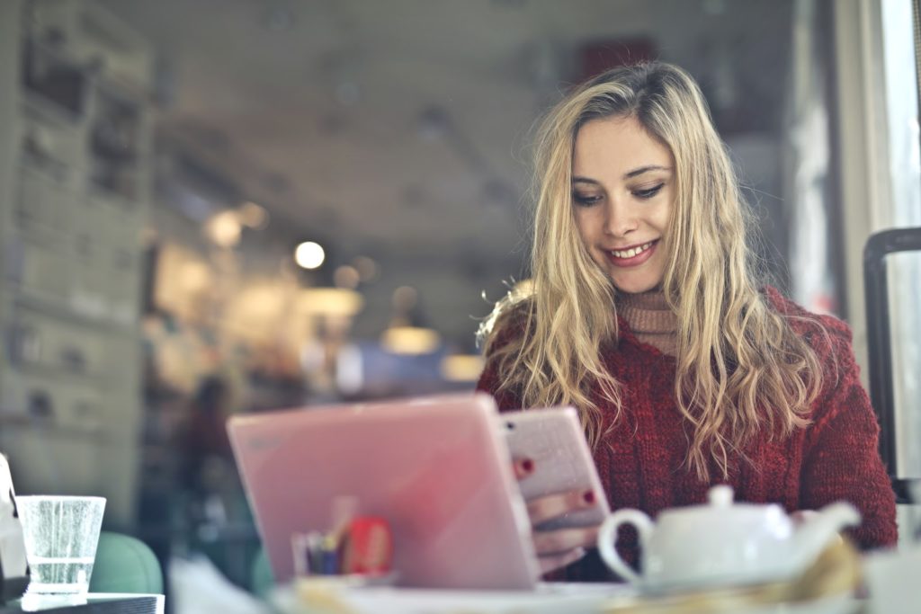 girl working on mobile device and laptop-computer