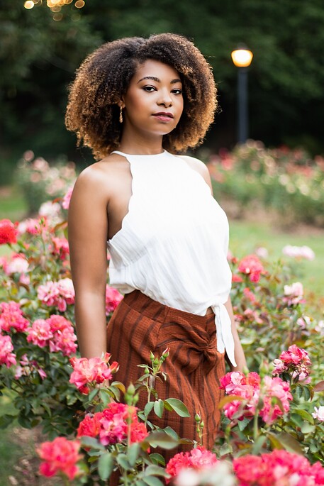 portrait of a lady posing in a rose garden