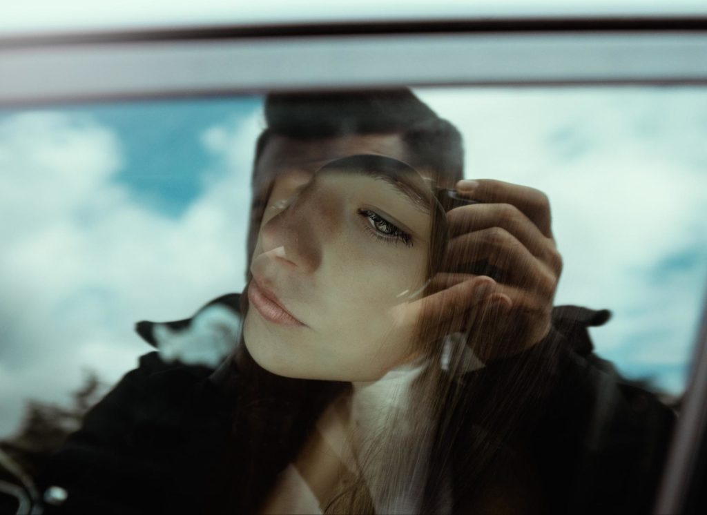 Thoughtful woman looking through car window