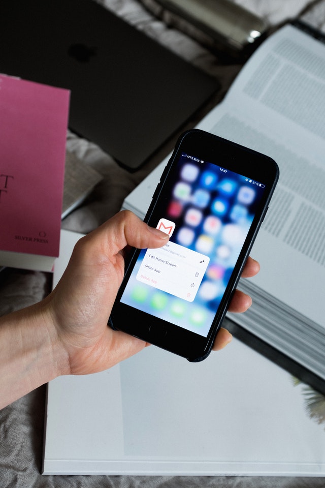 a hand holding an iphone