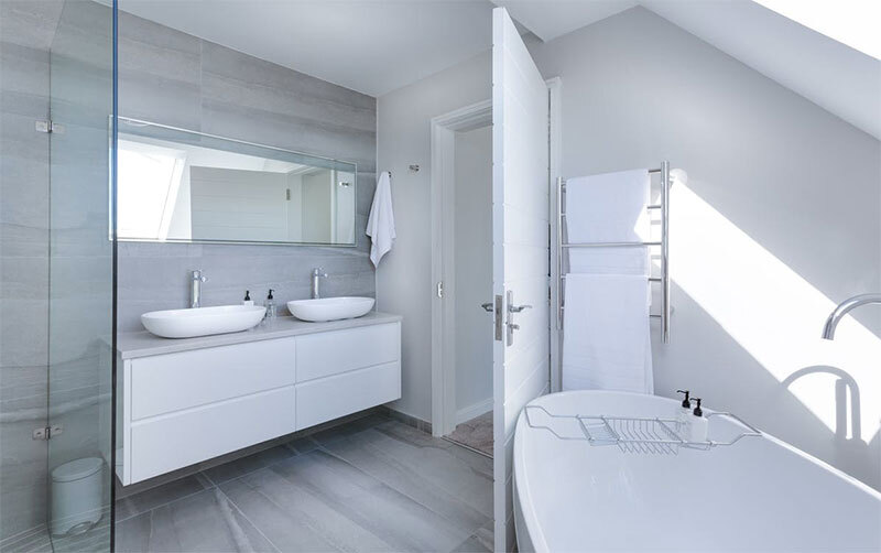 White Bathroom Interior with a bathtub and 2 sinks